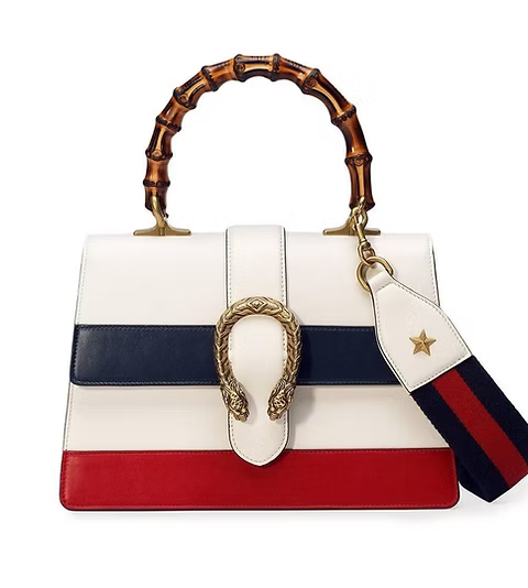 Designer handbag with bamboo handle, snake clasp, and color-blocked design on a white background